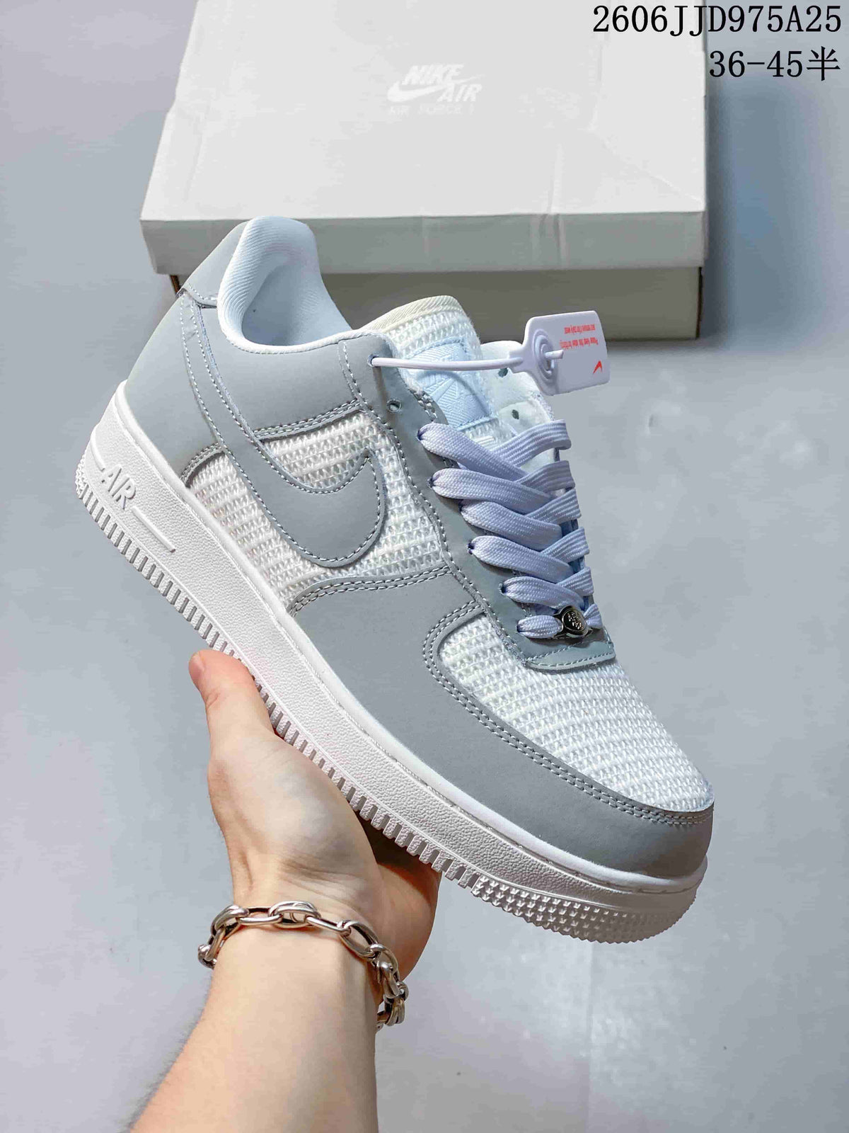Side view of a light gray and white low-top sneaker