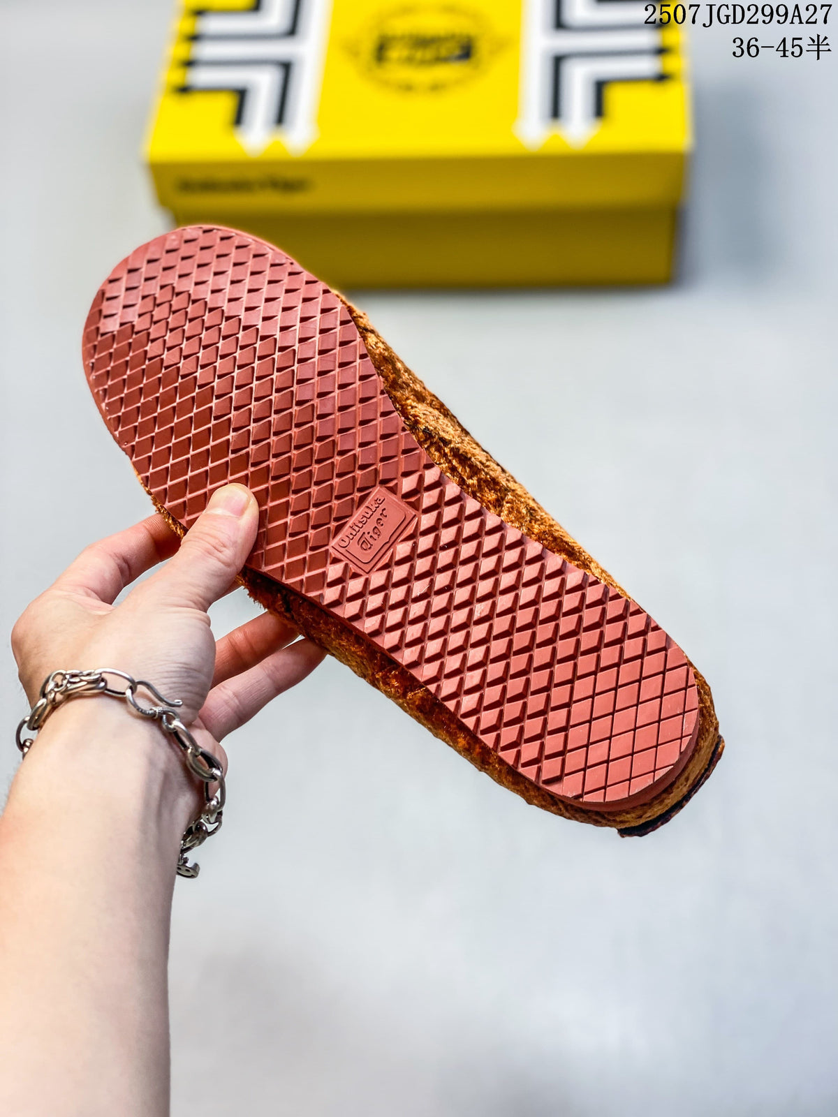Close view of the brown patterned outsole on a rust-brown sneaker