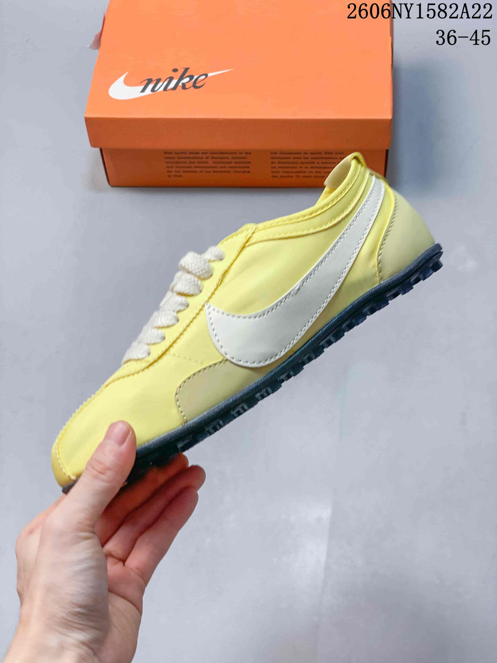 Side profile of a pale yellow Nike Moon Shoe OG sneaker with white Swoosh and dark outsole