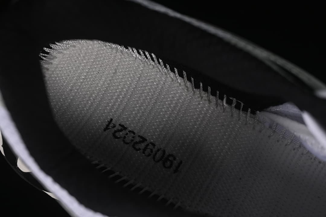Close-up inside the shoe showing a printed code on the insole.