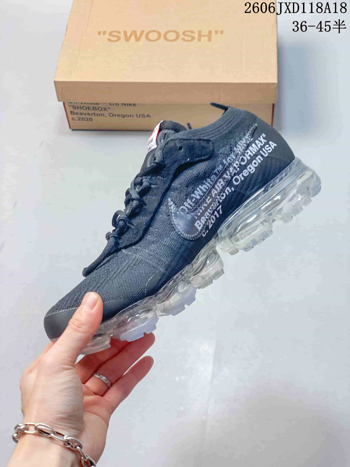 Side profile of the dark grey Nike Air VaporMax sneaker with printed details