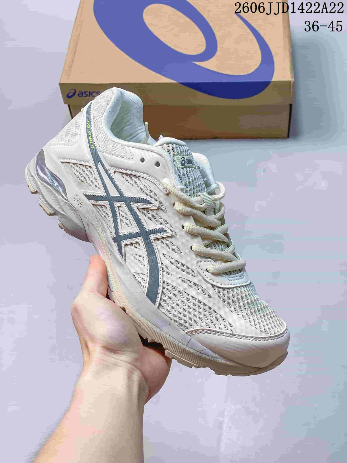 White ASICS GEL-FLUX shoe with dark blue-gray accents.