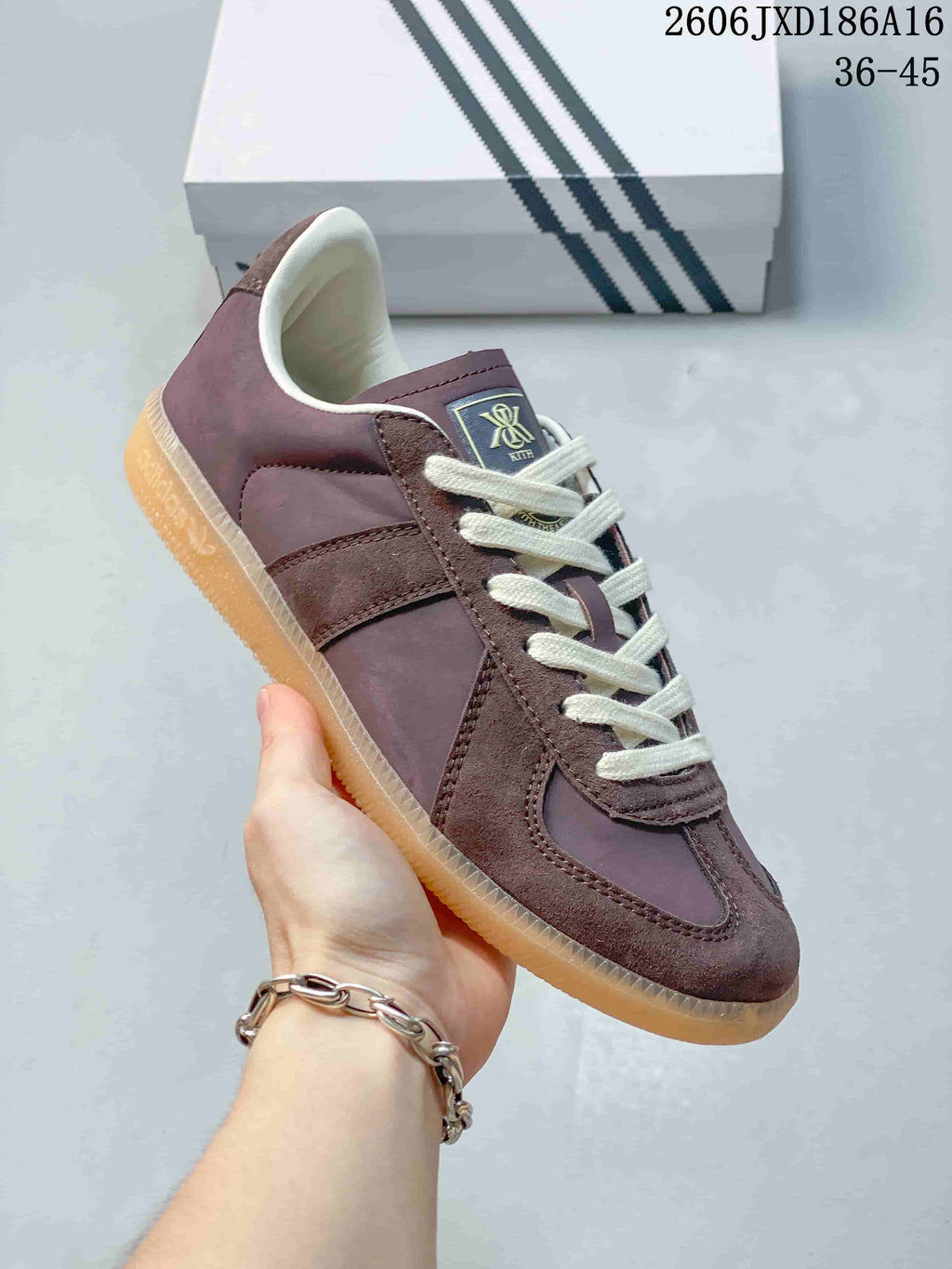 Angled side view of the purple-brown sneaker with suede-look overlays