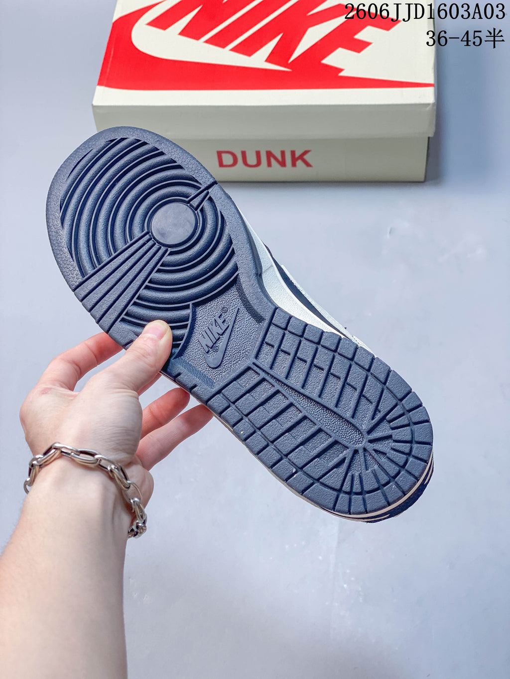 Close-up of the navy rubber outsole with circular tread on a Nike SB Dunk Low shoe