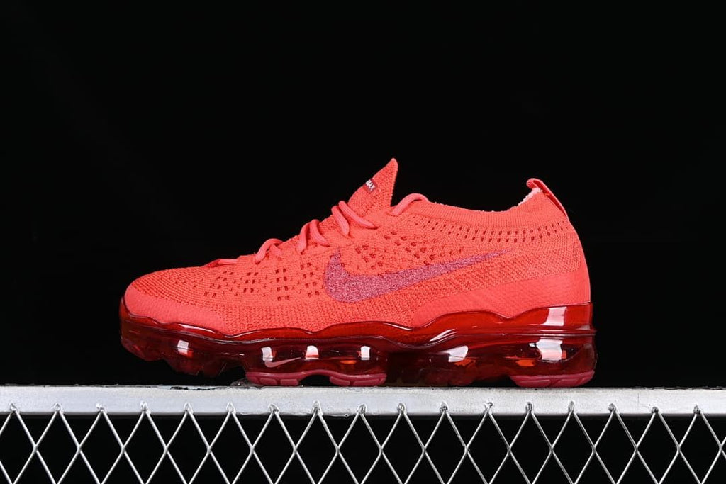 Side view of a red Air VaporMax 2023 Flyknit sneaker