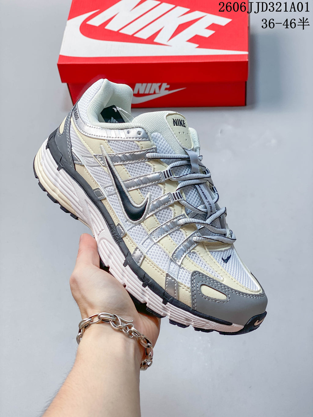 Side view of a white, gray, and pale yellow Nike P-6000 sneaker