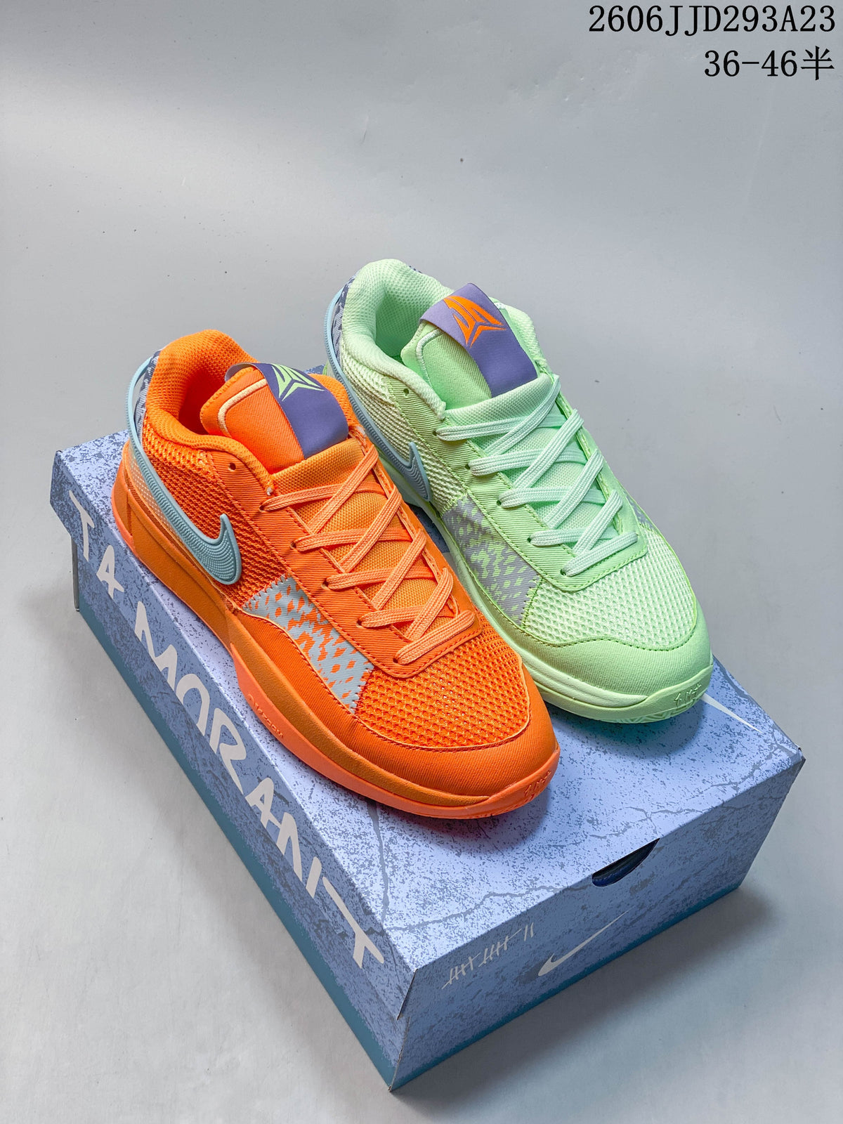 Orange and pale green Nike Ja 1 EP shoes displayed on a Ja Morant shoebox.