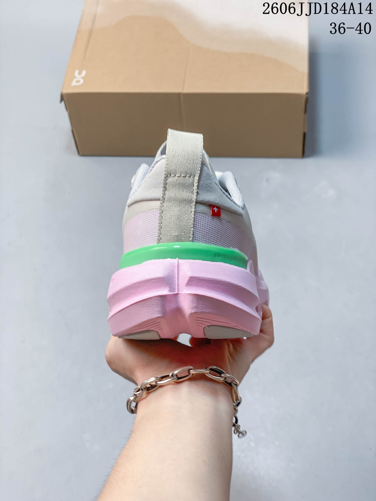 Rear view of the sneaker showing the layered pink heel and green accent
