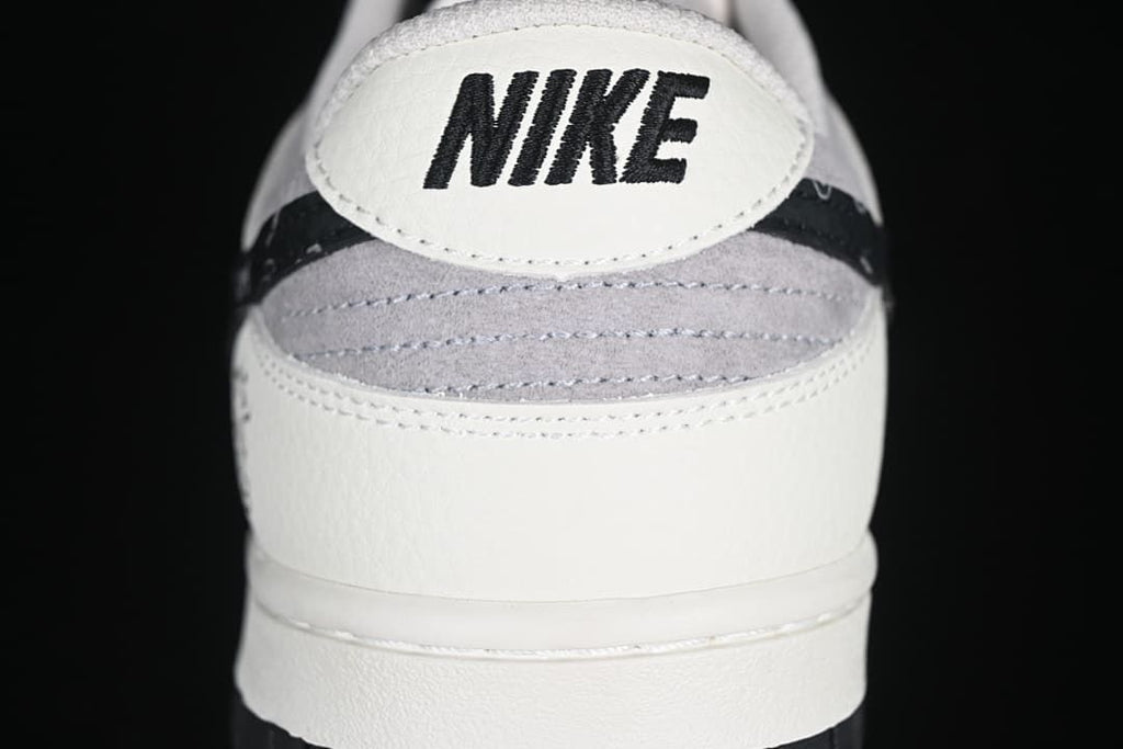 Rear view showing Nike branding, gray heel panel, and black patterned trim