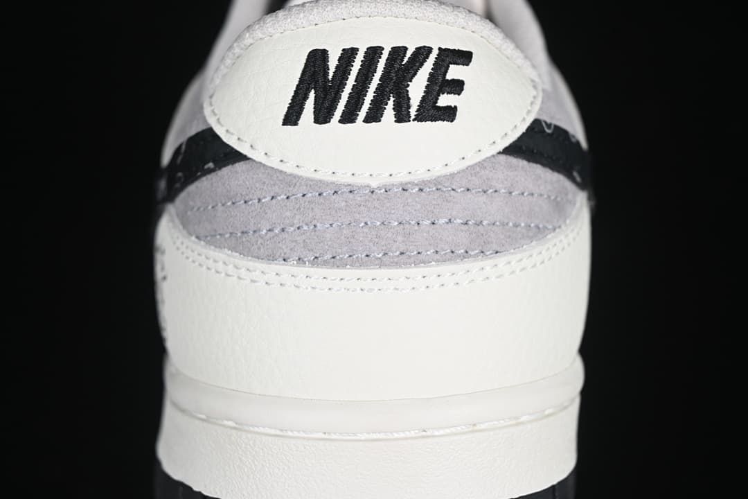 Rear view showing Nike branding, gray heel panel, and black patterned trim
