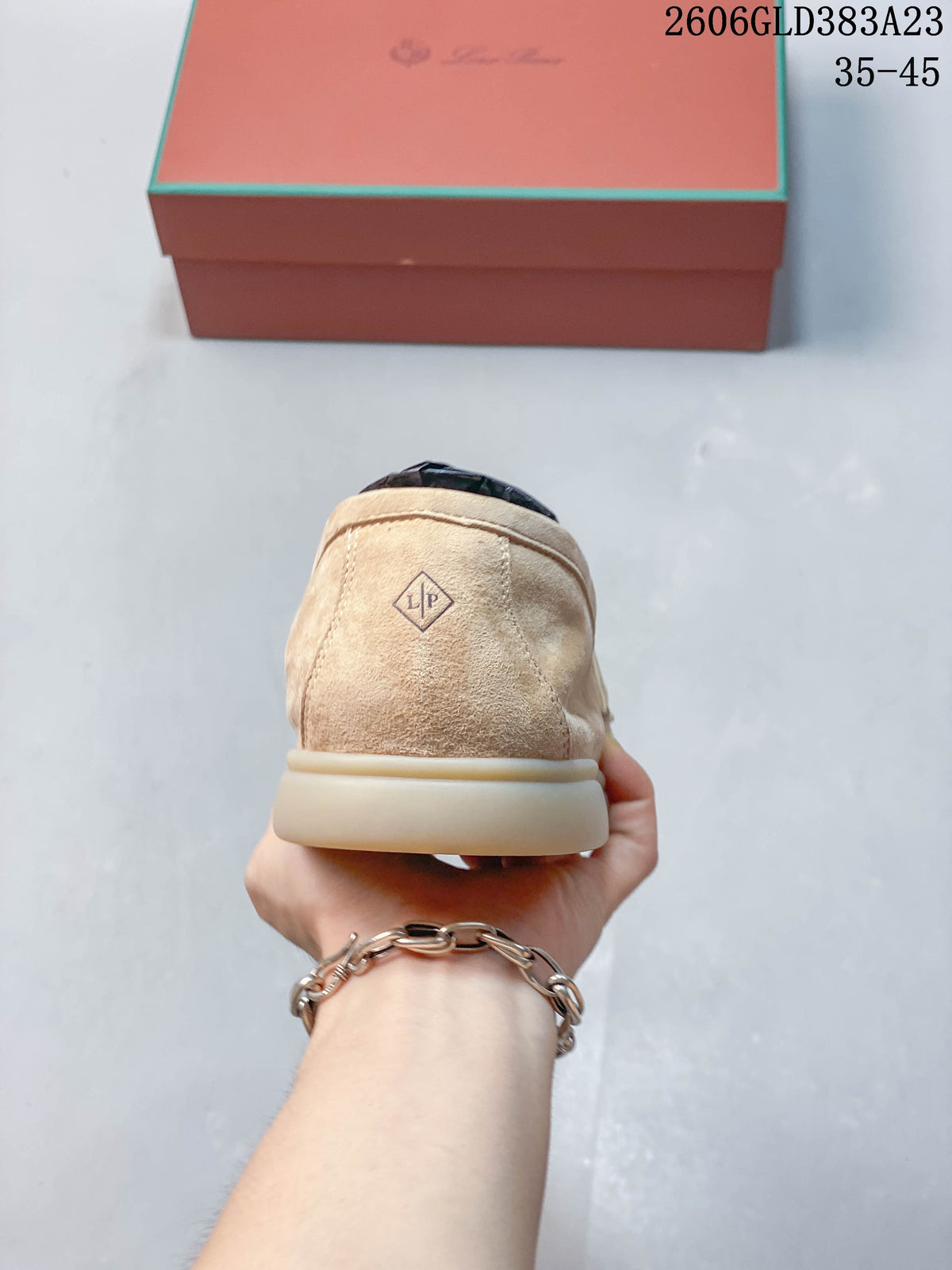 Rear view of a beige loafer showing the heel and sole