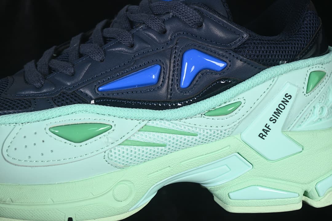 Close-up of layered navy and mint side panels with Raf Simons branding
