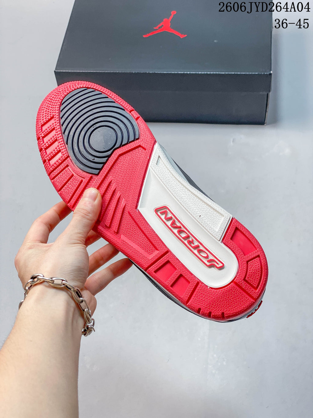 Underside of the Jordan sneaker showing a red and dark outsole