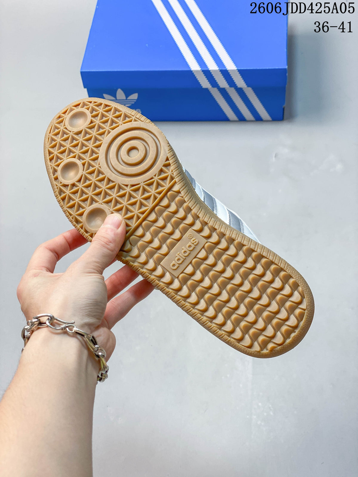 Underside of the sneaker showing the gum-colored outsole tread