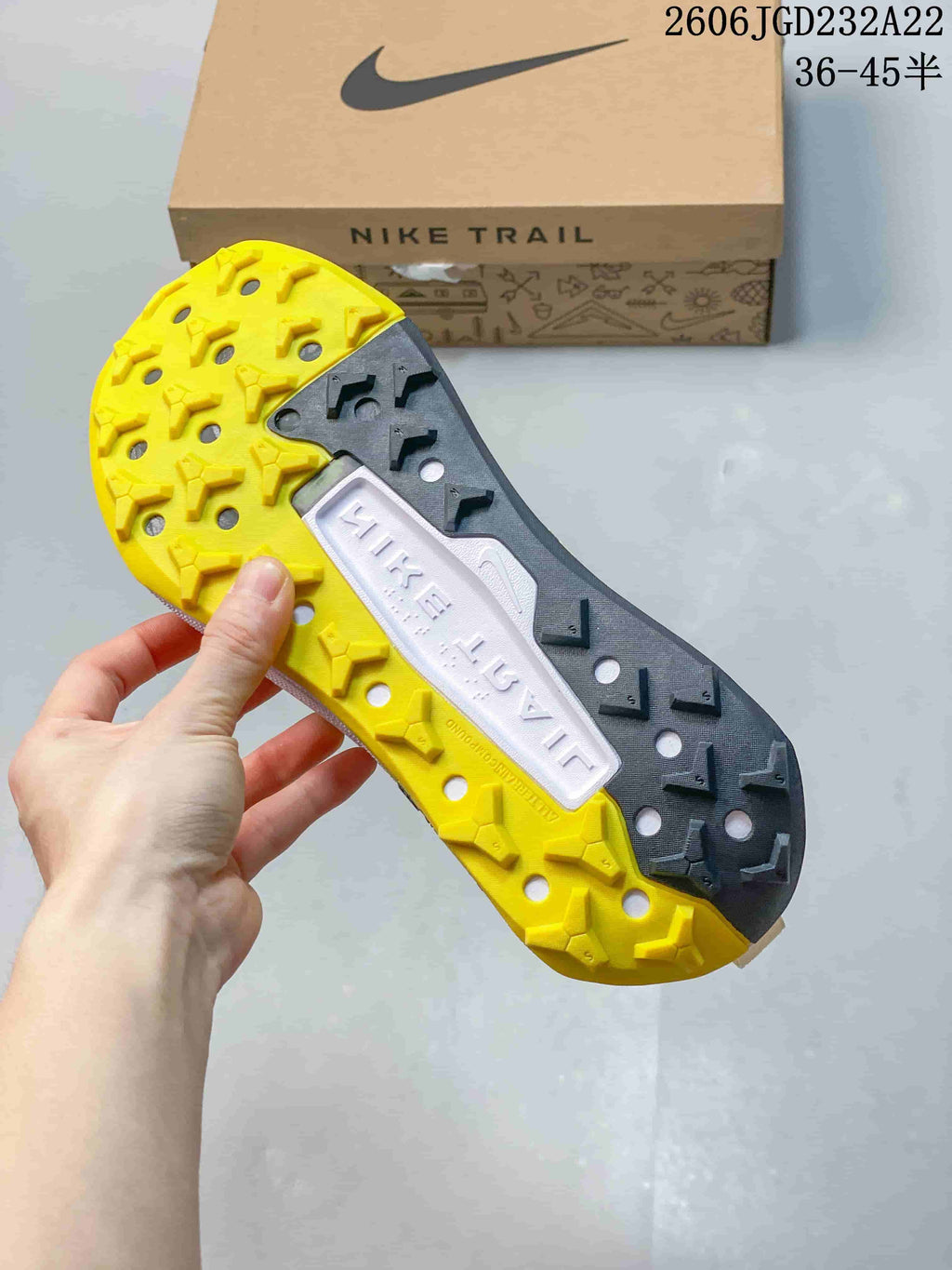 Close-up of the trail shoe outsole showing yellow and dark tread sections