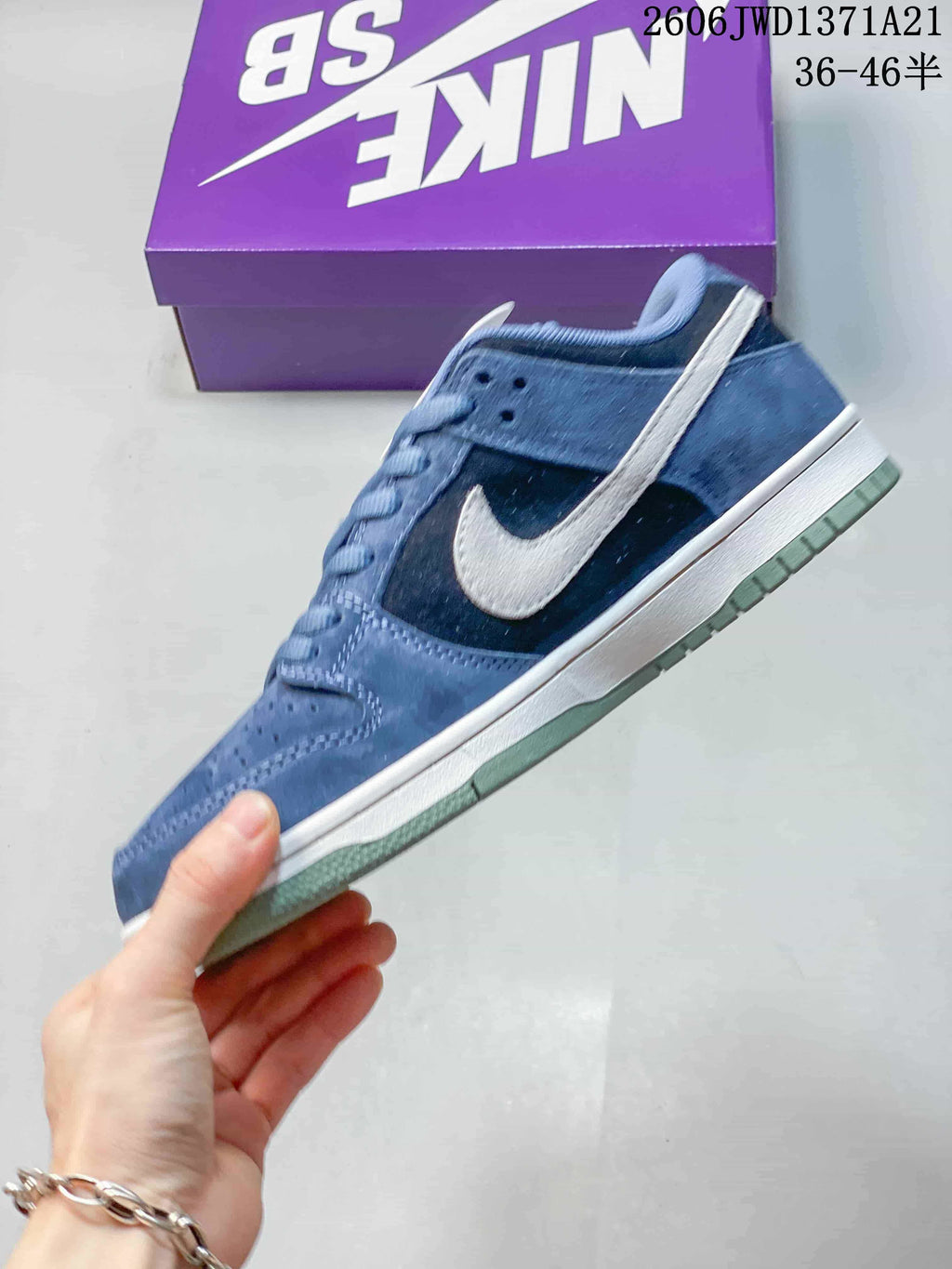Side profile of a blue Nike SB Dunk Low Pro sneaker with a light-colored Swoosh.