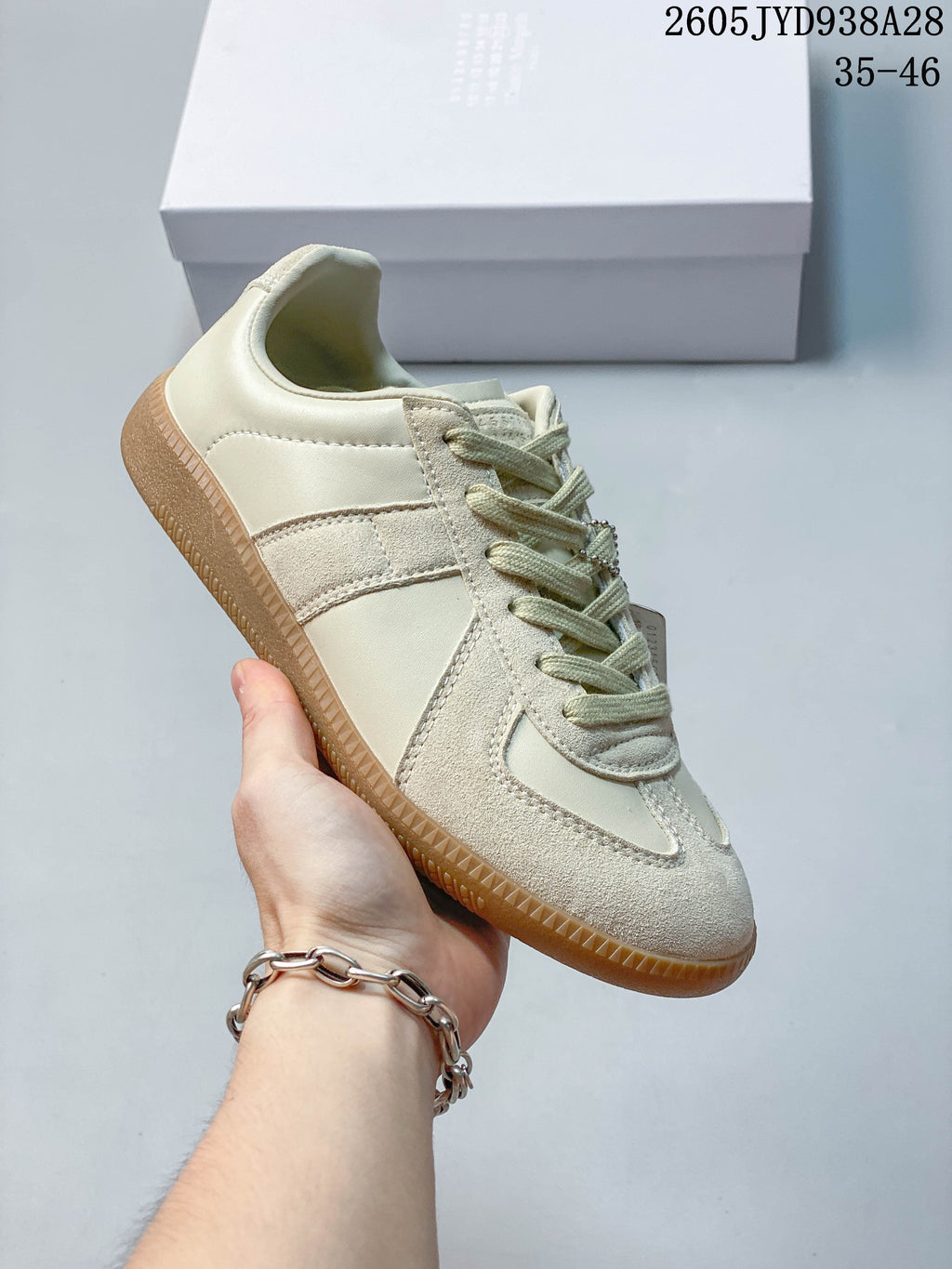 Side profile of the cream sneaker and gum-colored outsole