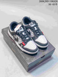 White and dark gray low-top sneakers with patterned side panels, red accent tabs, and a logo-patterned box.