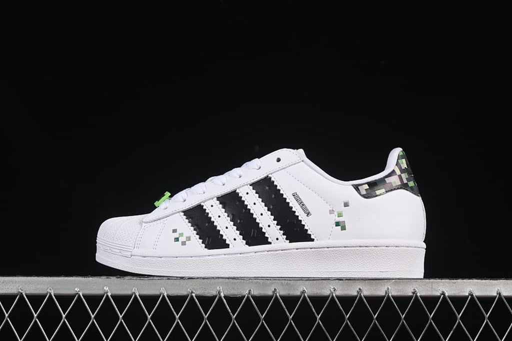 Side view of white adidas Superstar II J Minecraft sneakers with black stripes and pixel accents