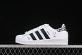 Side view of white adidas Superstar II J Minecraft sneakers with black stripes and pixel accents
