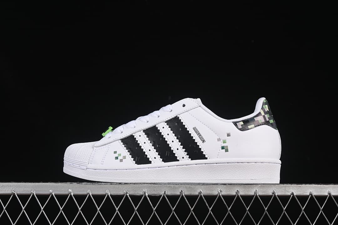 Side view of white adidas Superstar II J Minecraft sneakers with black stripes and pixel accents