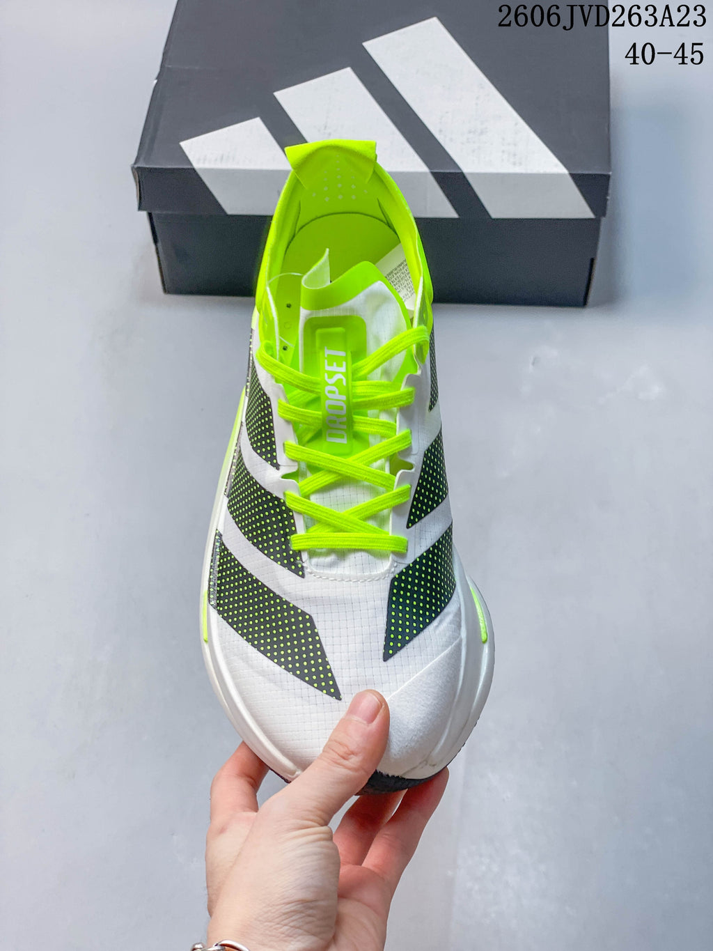 Top view showing the white upper, dark graphic panels and neon-yellow laces.