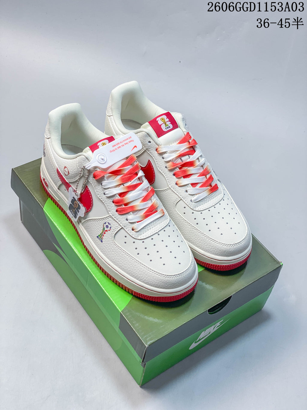 Pair of white and red Nike Air Force 1 low-top sneakers on a shoebox.