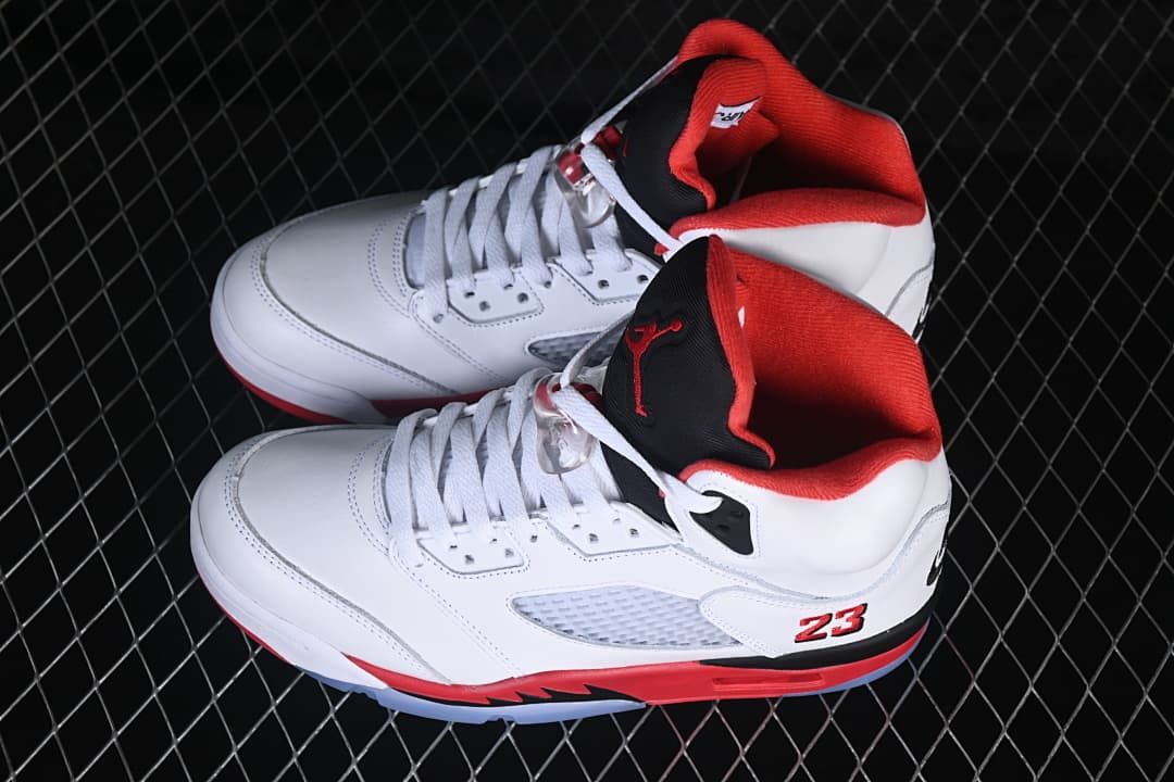 Pair of white, red, and black Air Jordan 5 Retro sneakers
