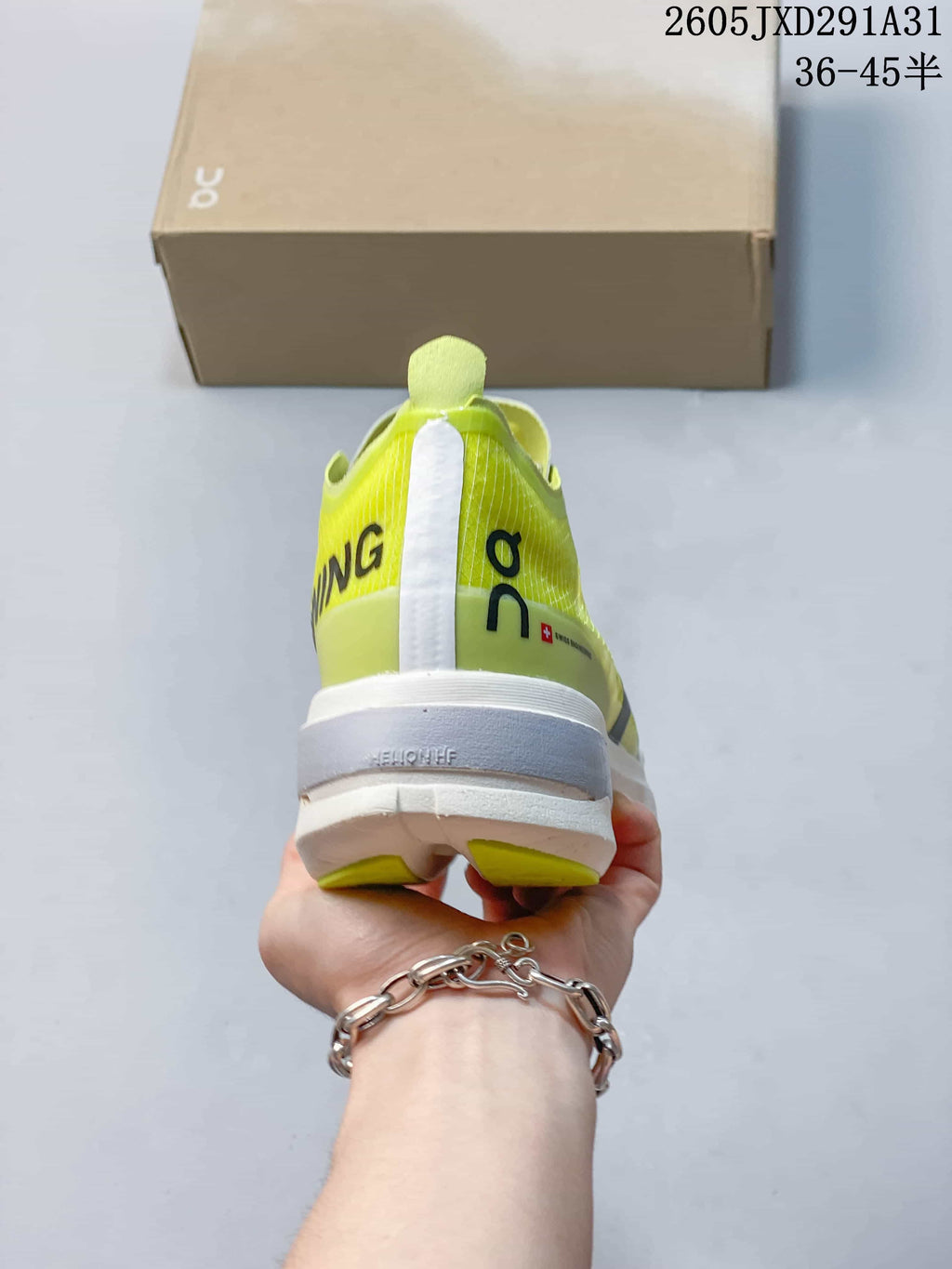 Rear view of the yellow-green running shoe showing its heel and midsole.