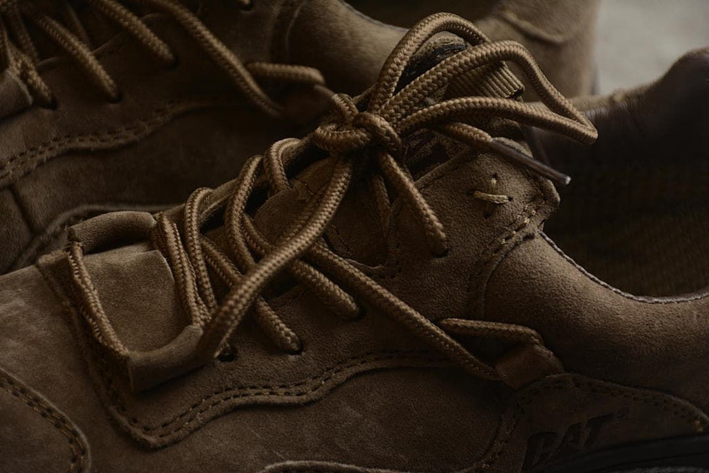 Close-up of the brown laces and stitched upper panels.