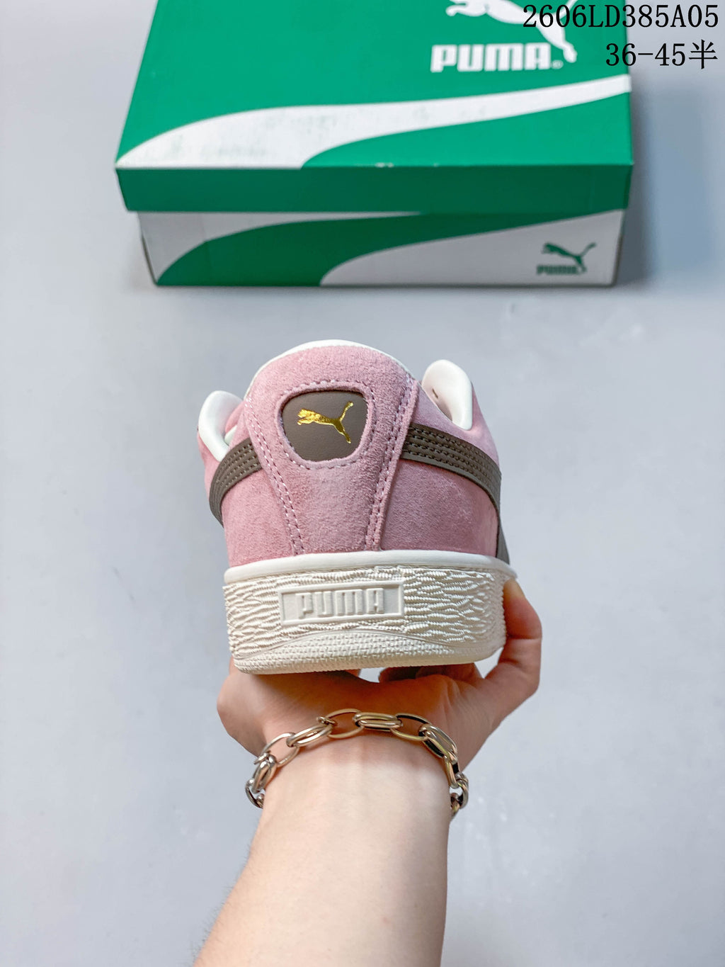 Rear view of a pink PUMA sneaker showing the heel detail and thick sole