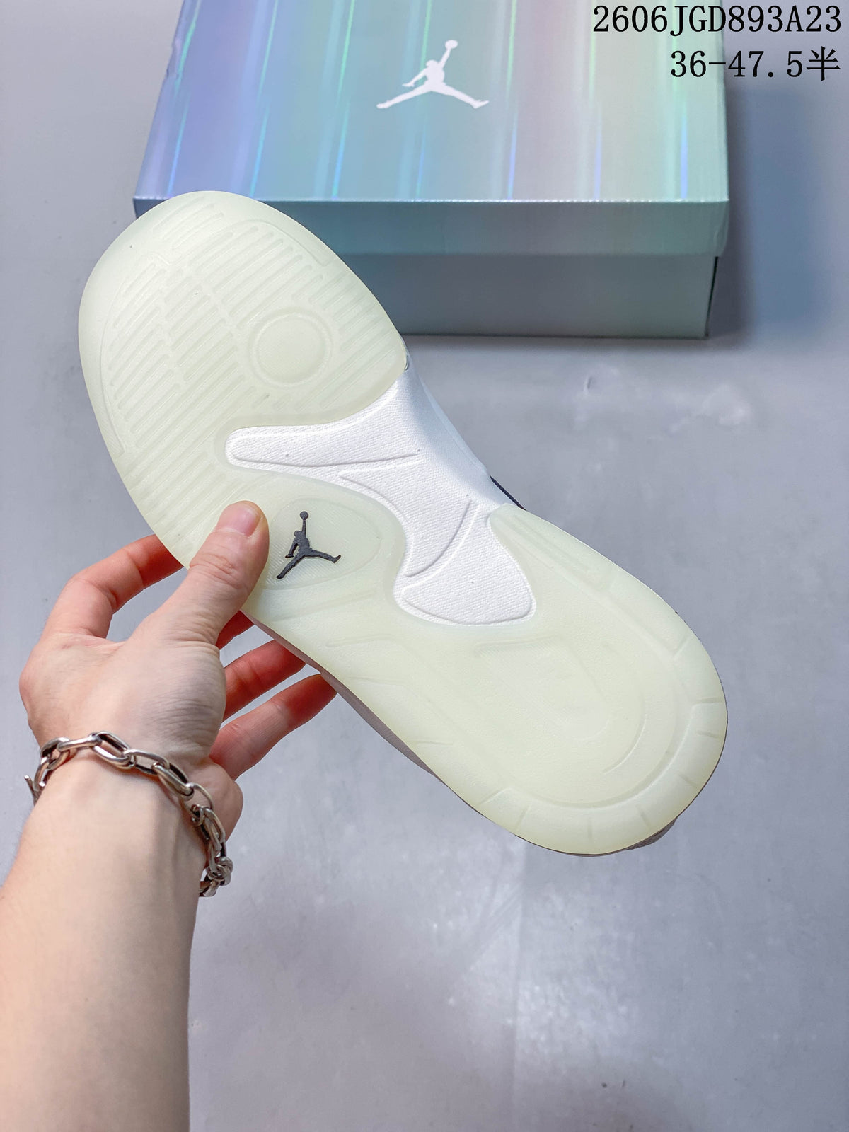 Underside of a Jordan Stadium 90 sneaker showing its pale, patterned outsole.