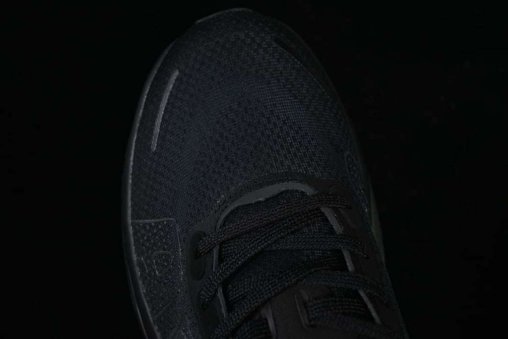 Top-down close-up of the black mesh-look toe and lace area.