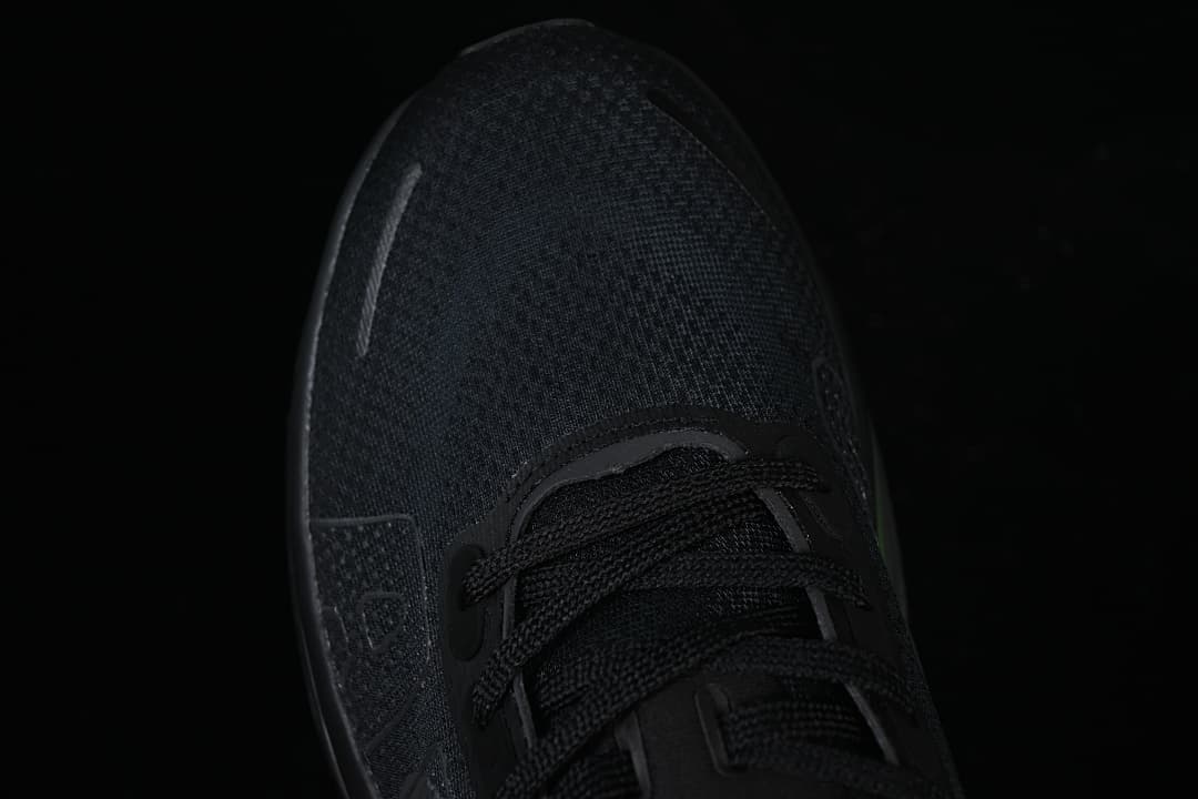 Top-down close-up of the black mesh-look toe and lace area.