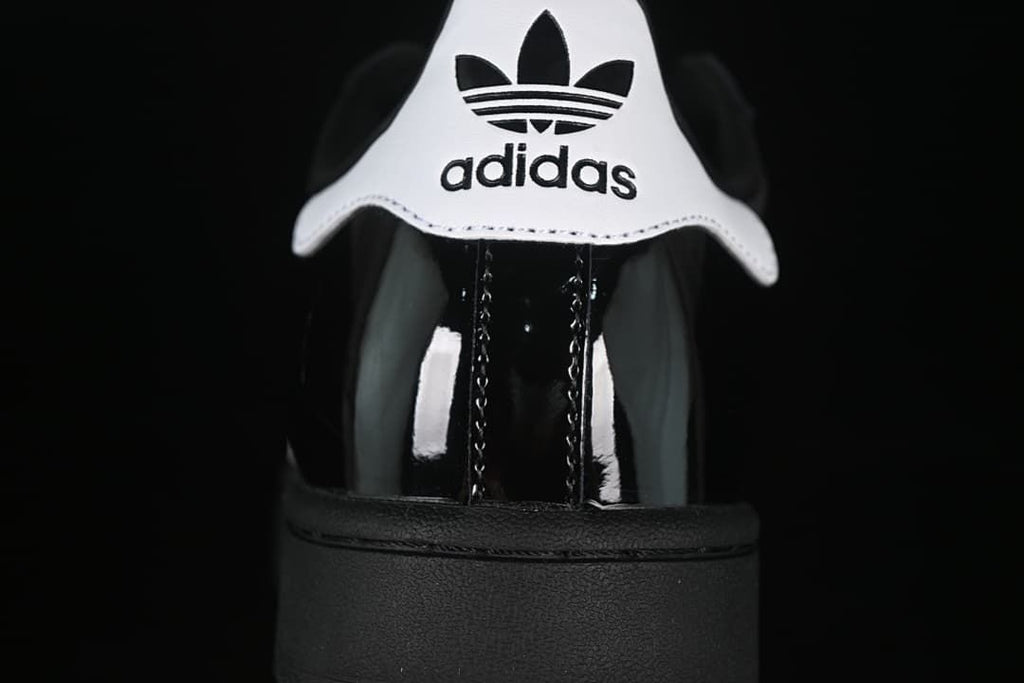 Close-up of the white heel tab with adidas Trefoil branding