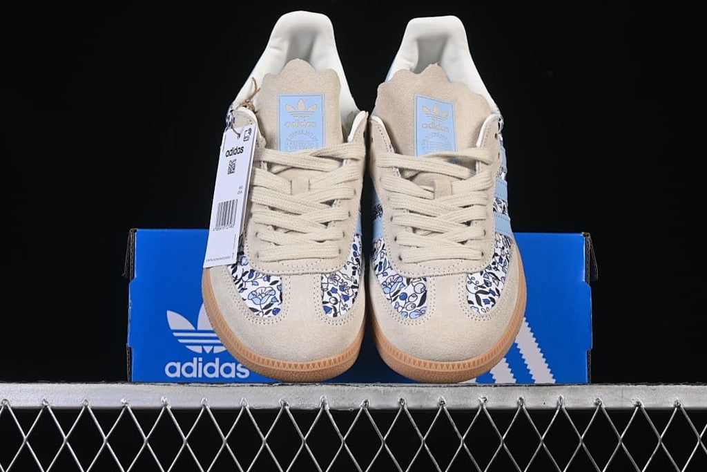 Front view of the pair placed on a blue adidas box