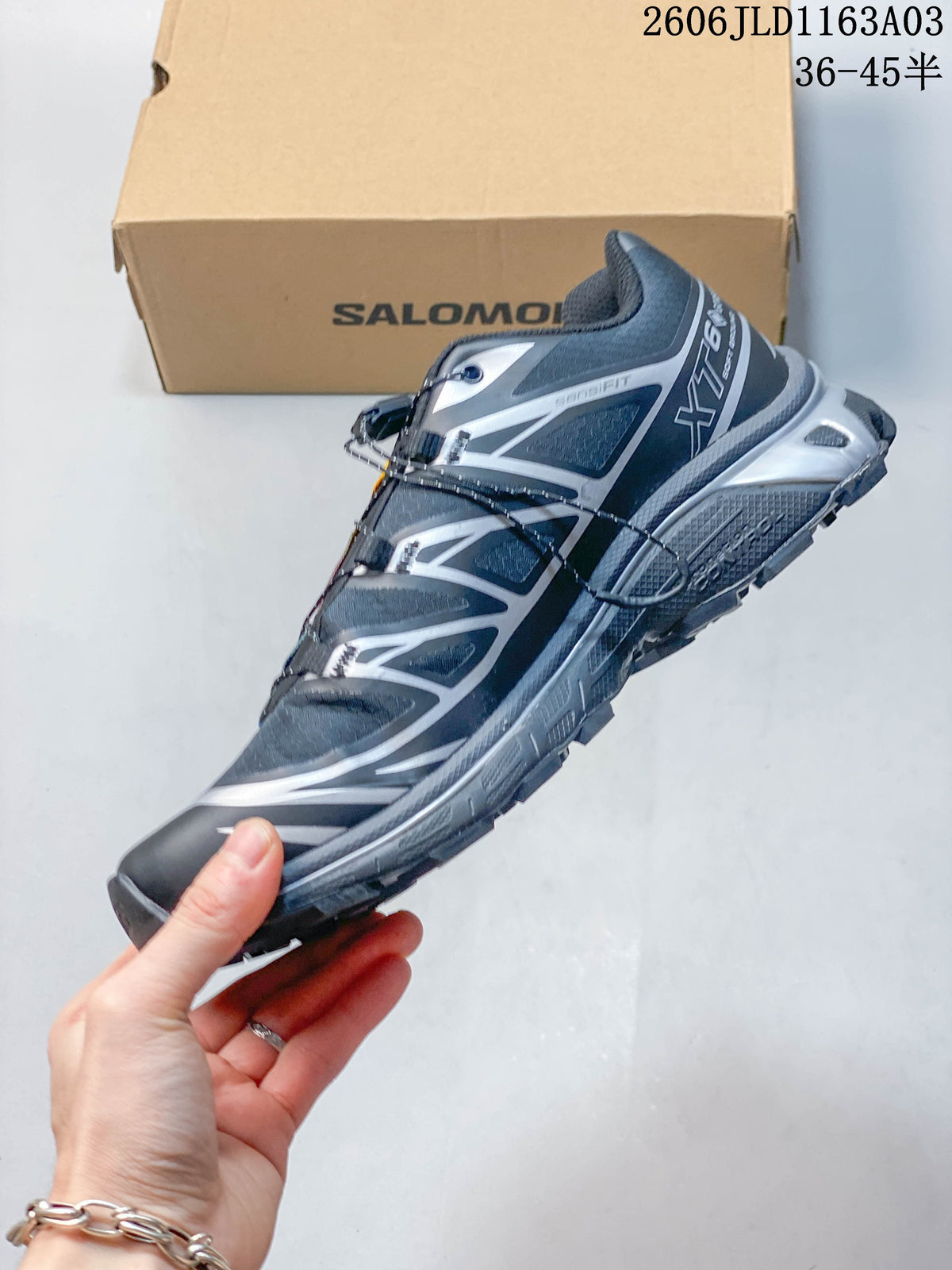 Side view of a Salomon XT-6 GTX sneaker with silver detailing and quick-lace closure