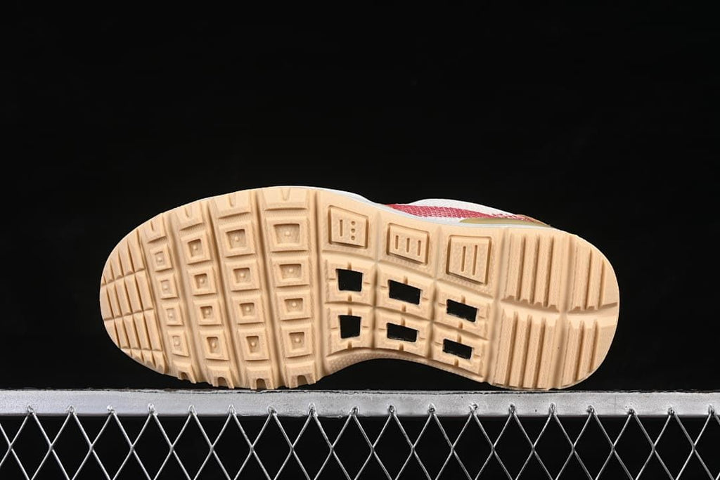 Underside of the sneaker showing a tan tread pattern