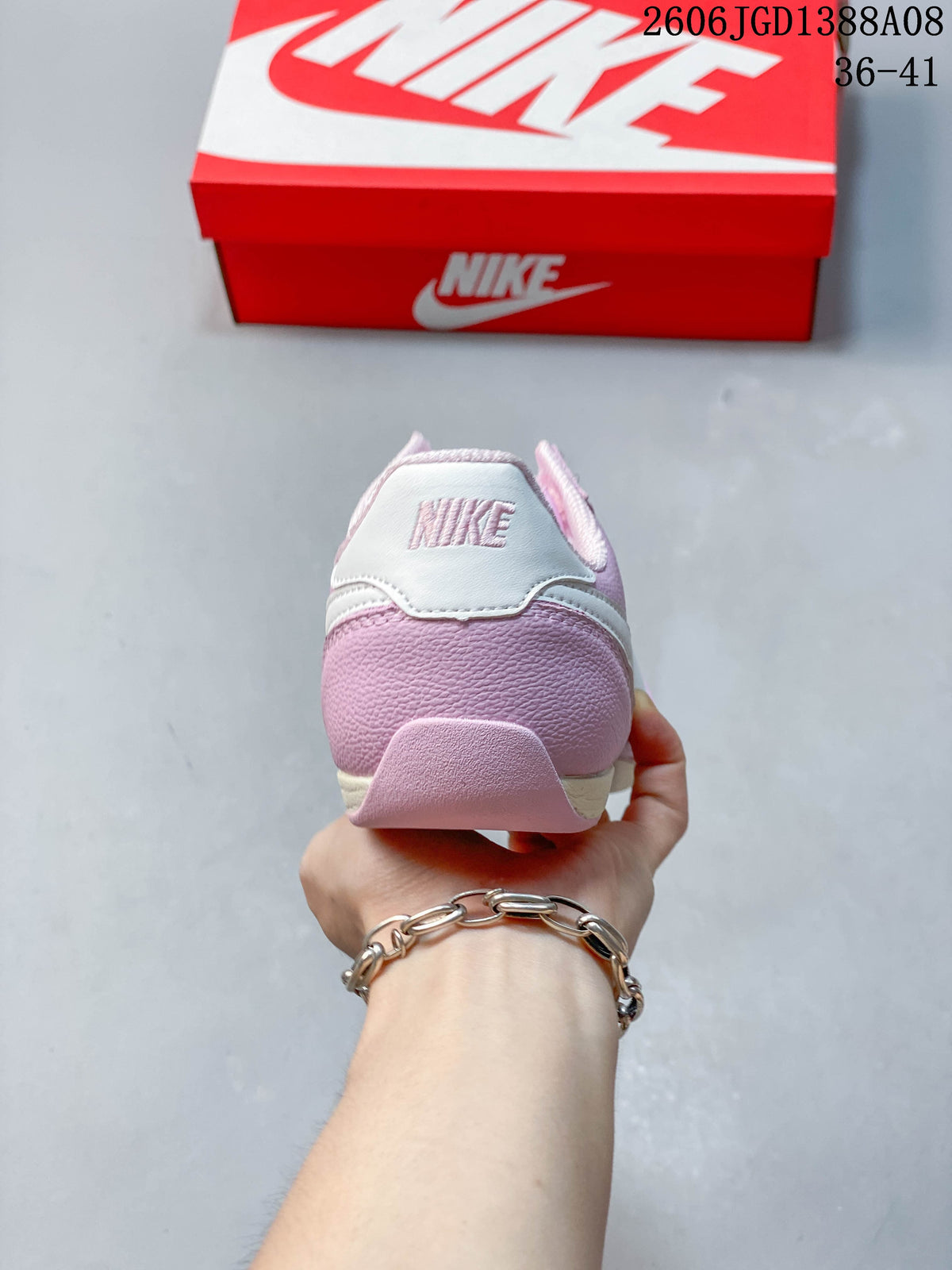 Rear view of the pink sneaker with a white heel panel
