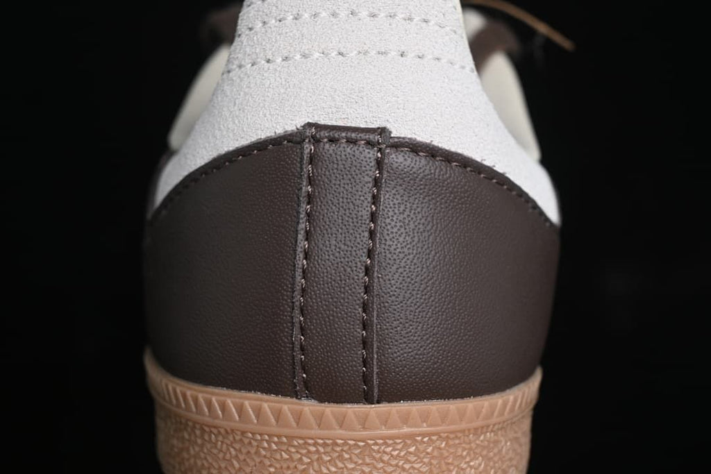 Rear close-up of the brown heel panel, grey heel overlay and gum sole