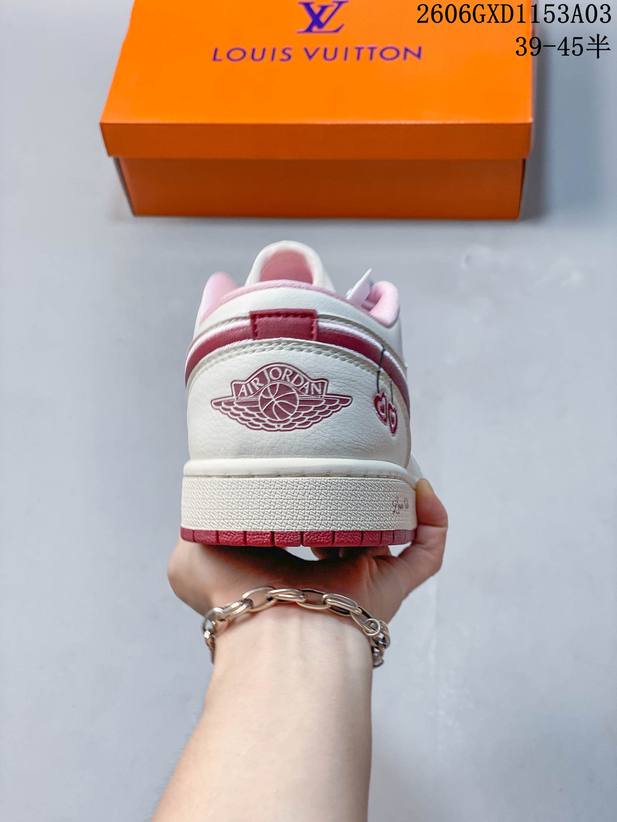 Rear view showing the heel panel and pink outsole of a white low-top sneaker.