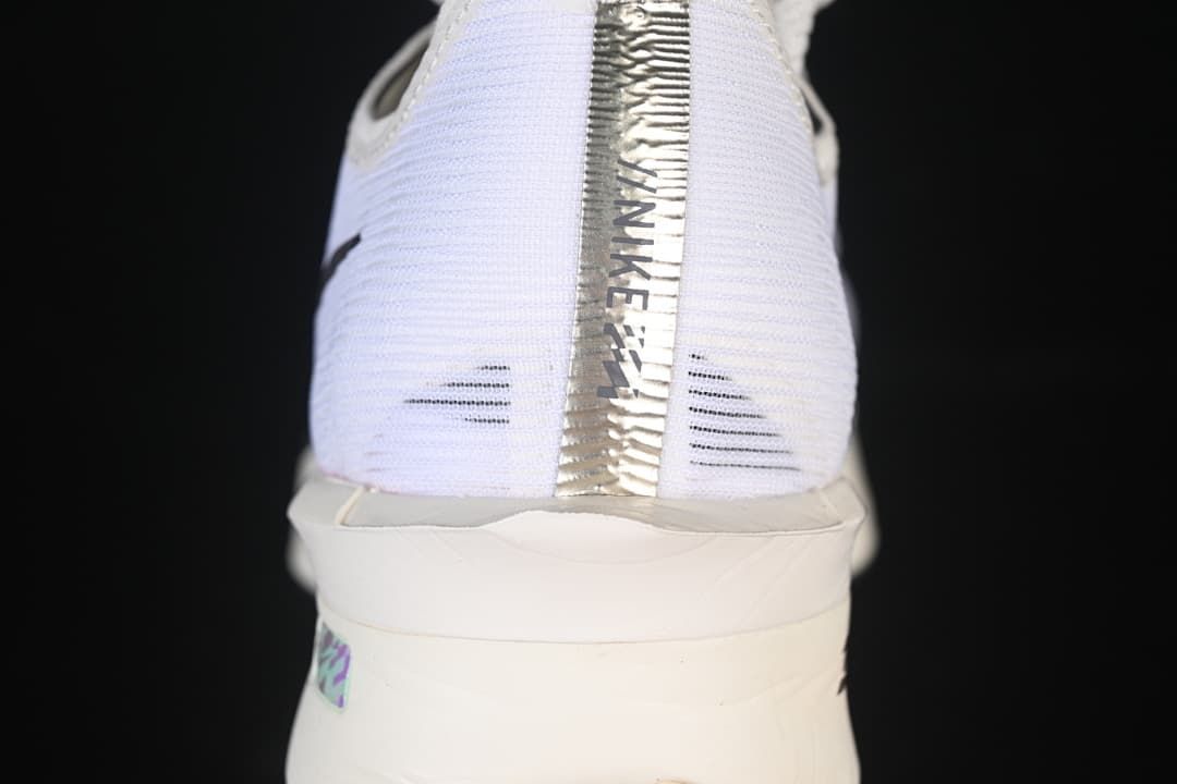 Rear view of the white shoe with metallic-look heel detail and sculpted sole