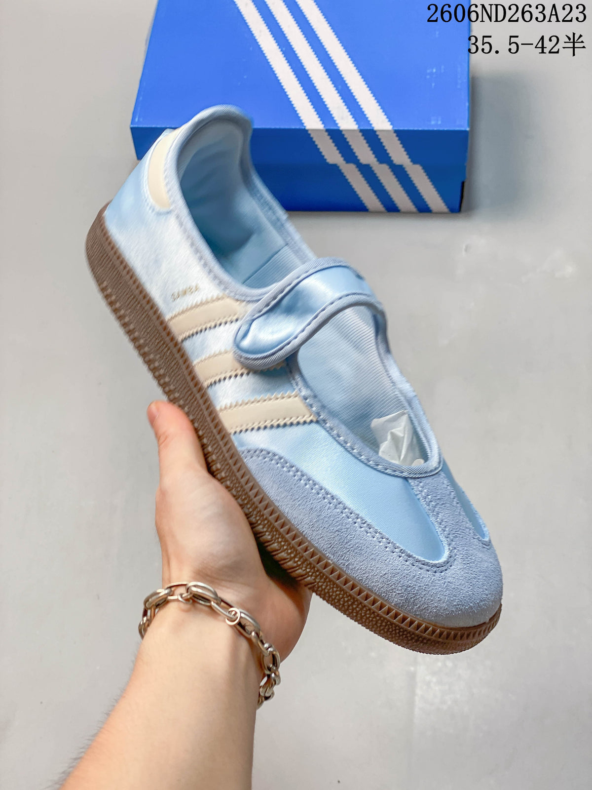 Angled view of a light blue Adidas Samba Jane sneaker with a single instep strap