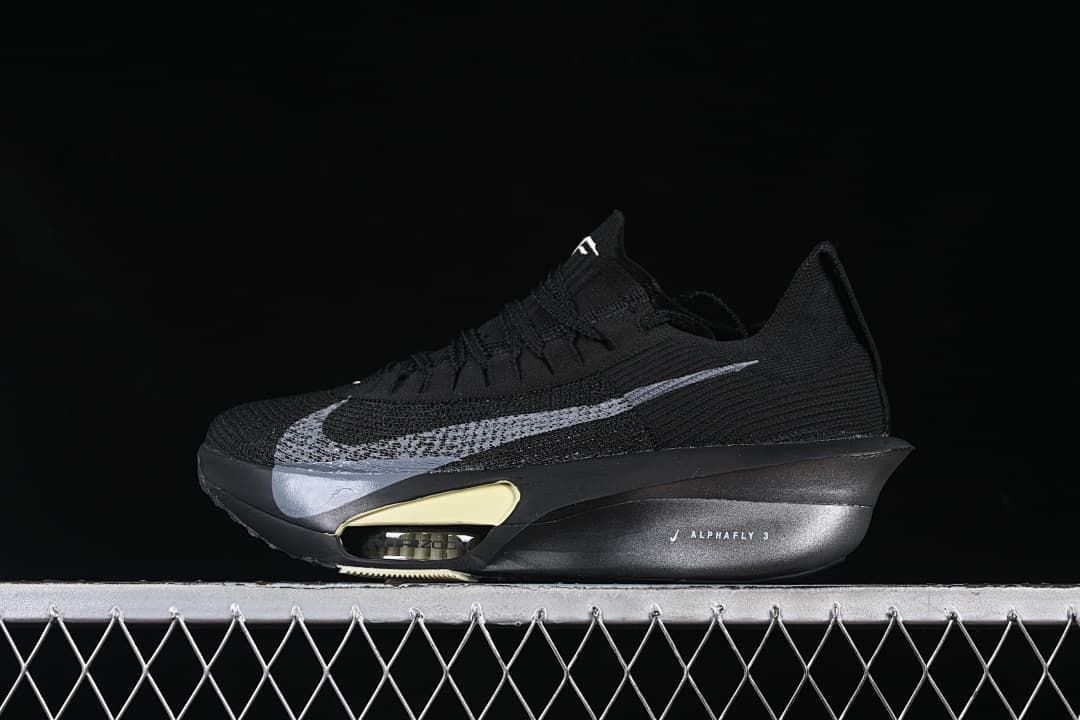 Side view of black Nike Alphafly 3 shoe with silver Swoosh and pale yellow sole accents