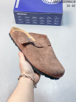 Side view of a brown suede-like Boston-style clog with an adjustable strap and metal buckle.
