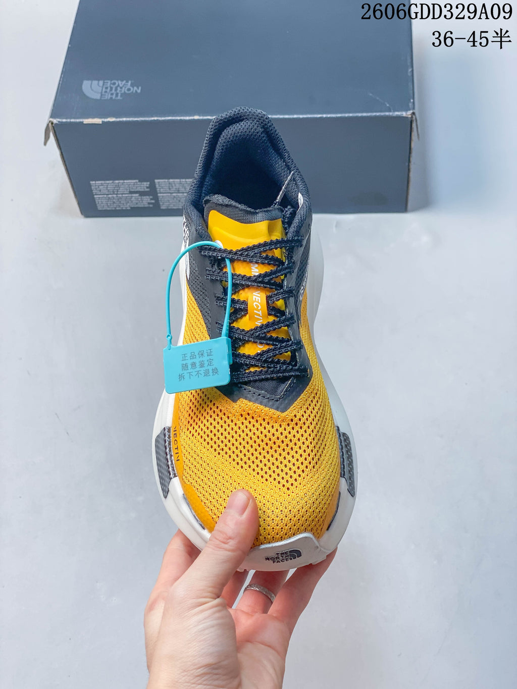 Top view of the shoe showing its laces, tongue, and yellow upper.