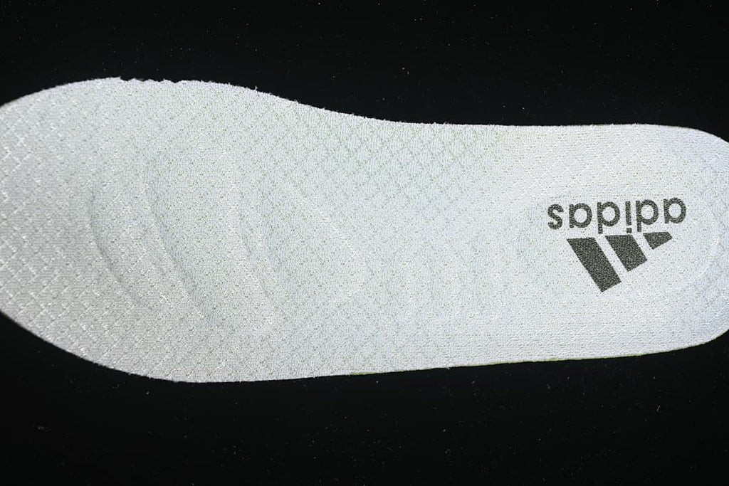 Close-up of a light-colored shoe insole with adidas branding