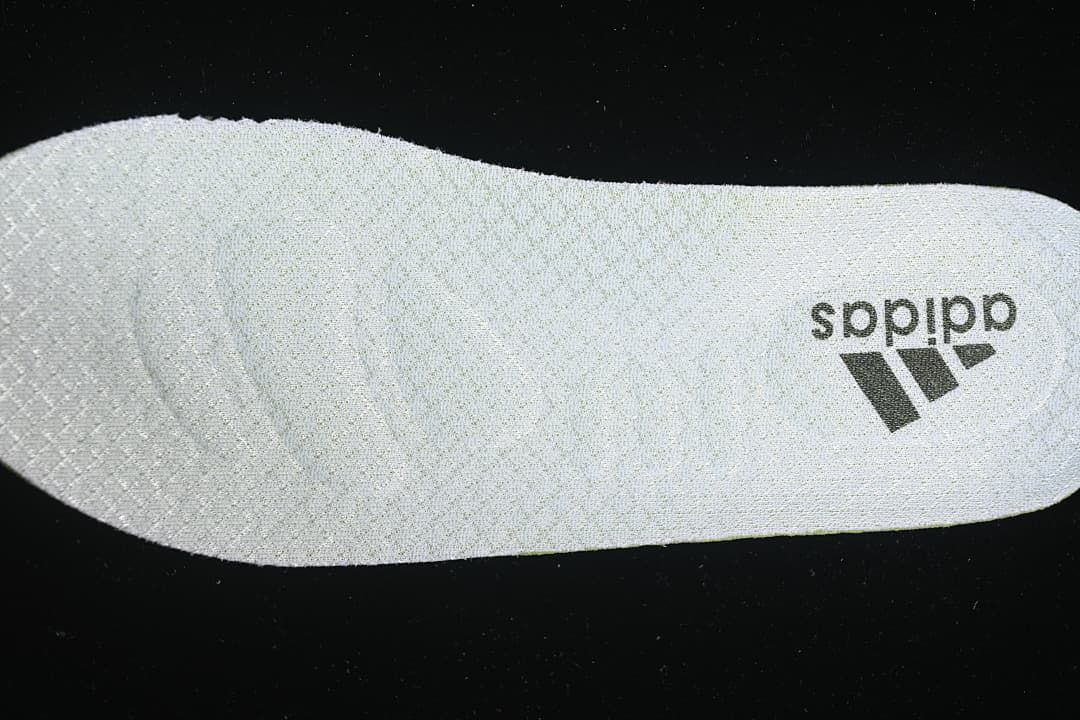 Close-up of a light-colored shoe insole with adidas branding
