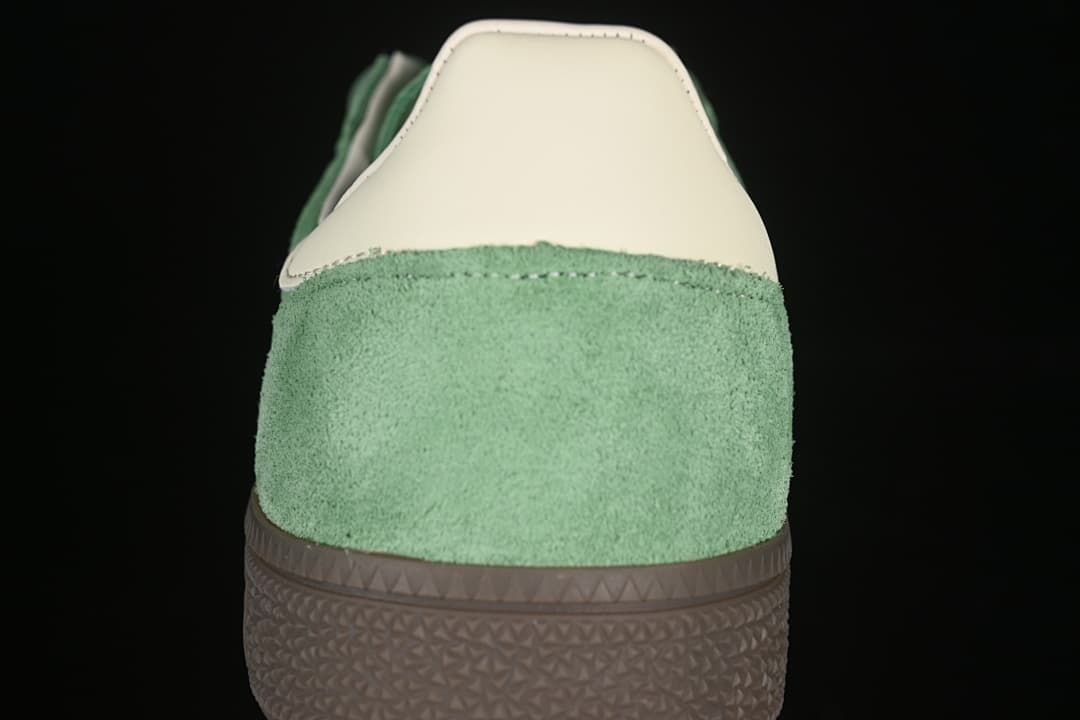 Rear view of the green sneaker with cream heel detail and brown sole