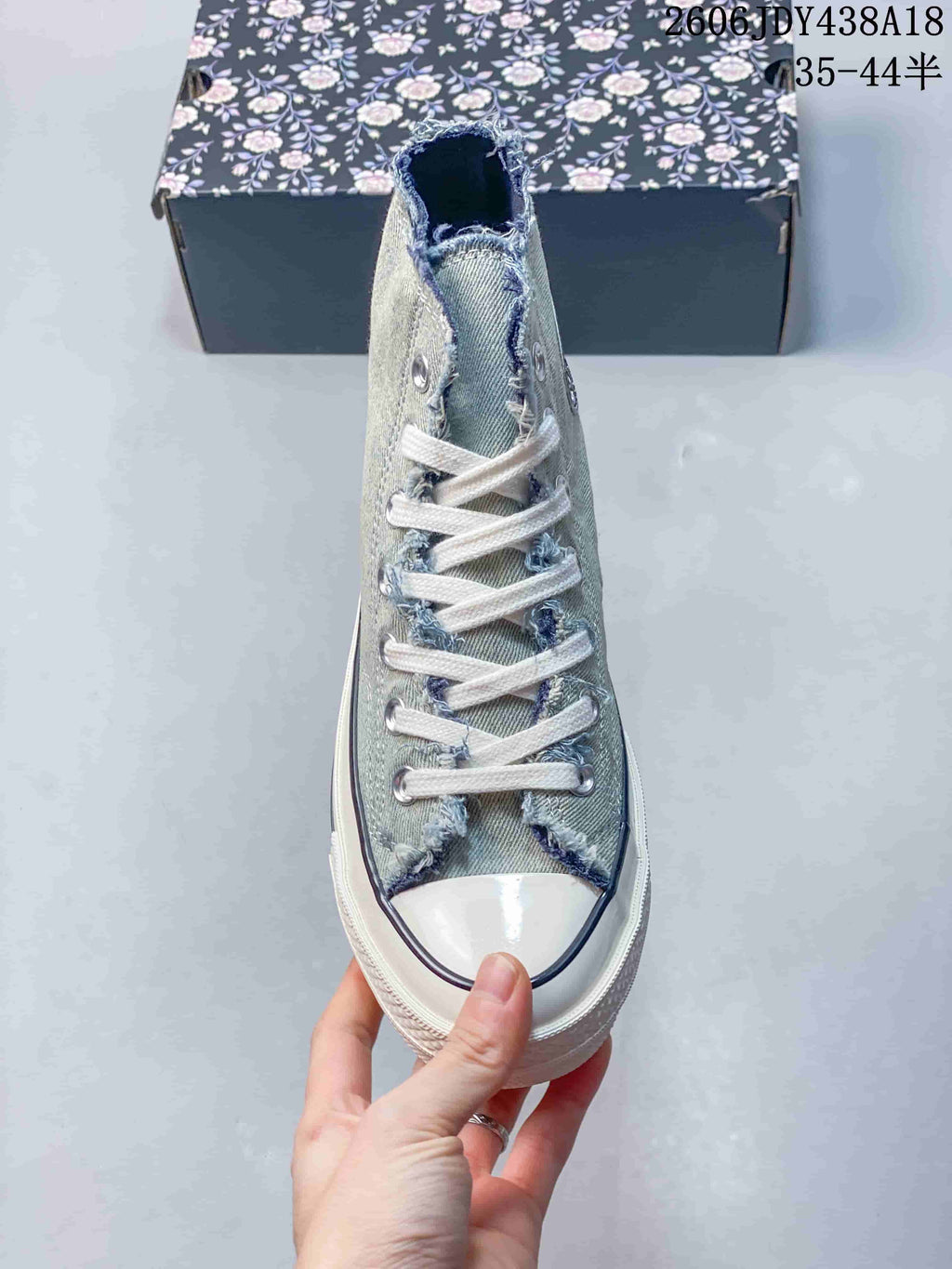 Front view showing the white laces, metal eyelets, and rubber toe cap